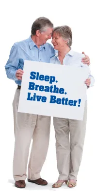 Image of a couple holding a sign that reads - Sleep. Breathe. Live Better.
